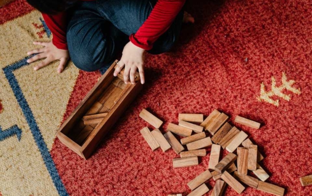 A child playing a game for NDIS life skills development.