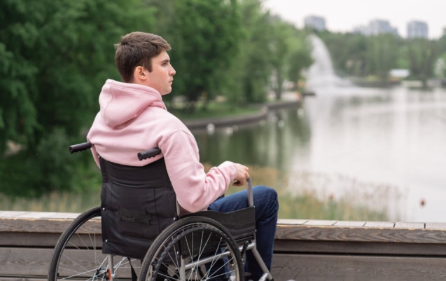 A man with disability travelling in a wheelchair for disability travel assistant.