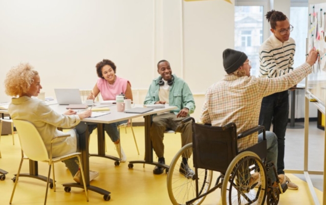 People and man in a wheelchair interacting for disability and community participation.