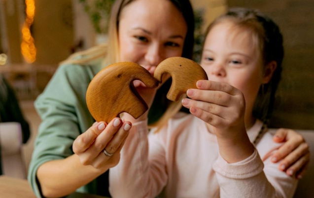 A female support worker playing elephant toy with a child for local ndis service provider.